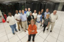 Amy Apon, center, stands with her team next to the Palmetto Cluster supercomputer.